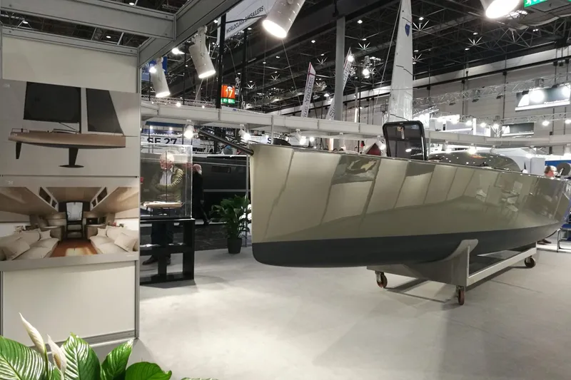 Slide: The Image of 2026 Brenta 30 yacht displayed at a boat show, featuring sleek design and modern interior. - 2