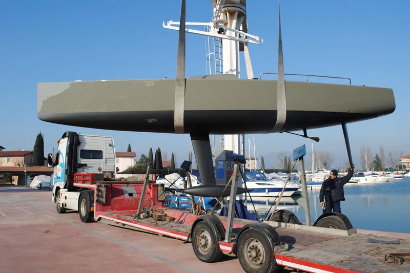 Slide: The Image of 2026 Brenta 30 yacht being transported on a trailer near a marina. - 10