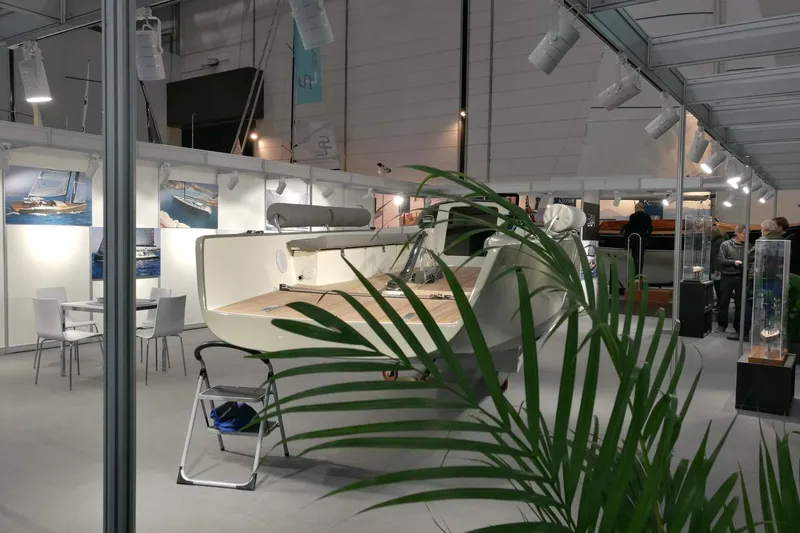 Slide: The Image of 2026 Brenta 30 sailboat displayed at an indoor boat show with informational exhibits. - 3