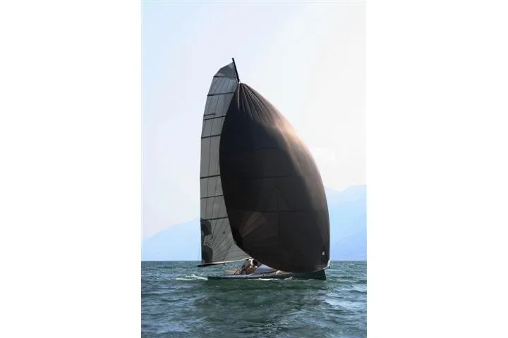 Slide: The Image of Sailing yacht Brenta 30, 2026 model, with black sails on open water. - 14