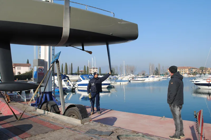 Slide: The Image of Two people inspecting a 2026 Brenta 30 sailboat at a marina. - 11