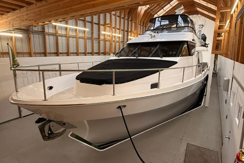 The Image of Custom 2000 motor yacht on calm water, featuring sleek design and spacious deck. - 0