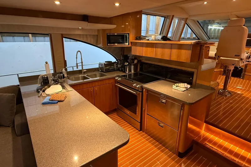 Slide: The Image of Luxurious interior of a 2000 Northern Pacific Motor Yacht with elegant wood finishes and modern amenities. - 11