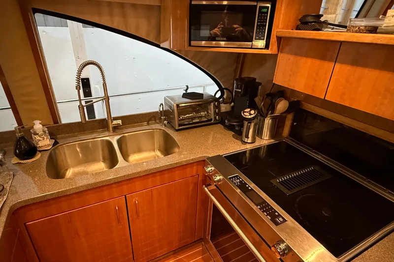 Slide: The Image of Luxurious interior of 2000 Northern Pacific Motor Yacht with wood flooring and modern kitchenette. - 14