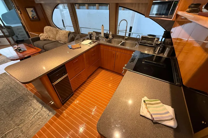 Slide: The Image of Luxurious kitchen interior of 2000 Northern Pacific Motor Yacht with modern appliances and wood finish. - 15