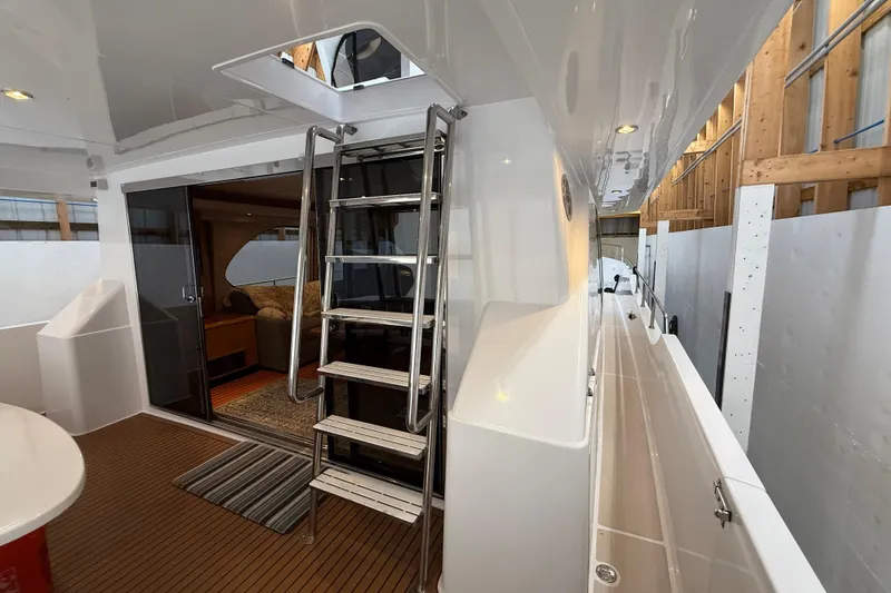 Slide: The Image of Northern Pacific Motor Yacht 2000 in a wooden boathouse, showcasing sleek design and craftsmanship. - 2