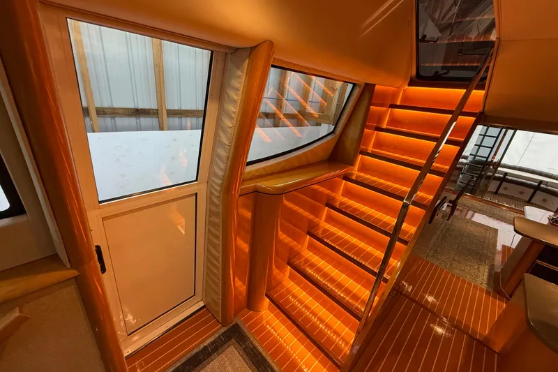Slide: The Image of Interior of 2000 Northern Pacific Motor Yacht with helm, seating, and wood finishes. - 23