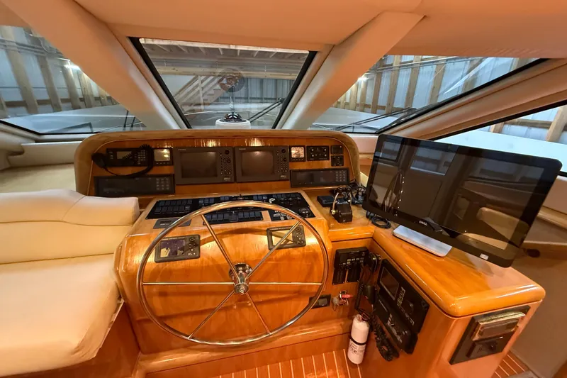 Slide: The Image of Luxurious helm of a 2000 Northern Pacific Motor Yacht with leather seating and modern controls. - 25