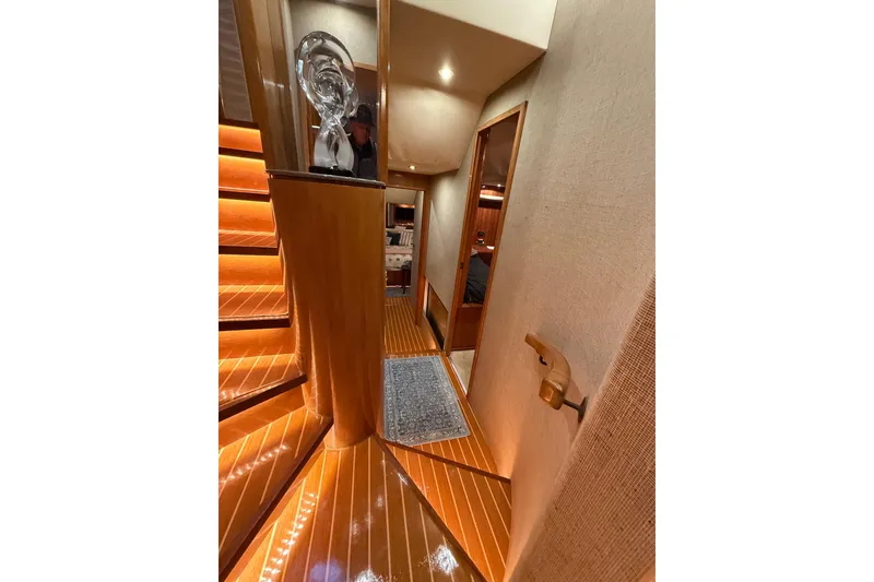 Slide: The Image of Staircase inside 2000 Northern Pacific Motor Yacht with wooden steps and ambient lighting. - 34
