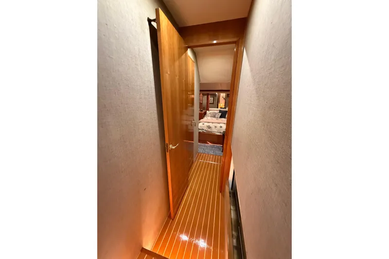 Slide: The Image of Luxurious interior of 2000 Northern Pacific Motor Yacht with illuminated wooden staircase. - 35