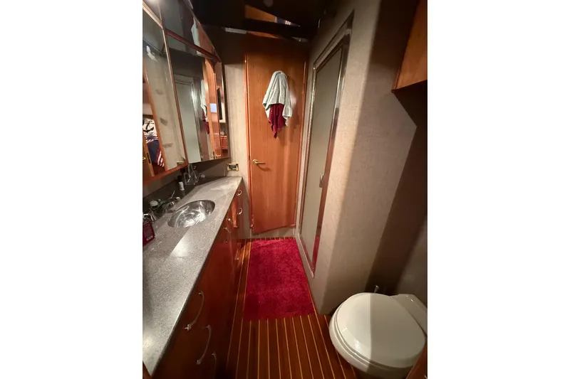 Slide: The Image of Luxurious bathroom in 2000 Northern Pacific Motor Yacht with modern fixtures and wooden cabinetry. - 44