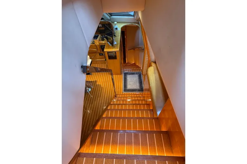 Slide: The Image of Luxurious interior of 2000 Northern Pacific Motor Yacht with illuminated wooden staircase. - 54