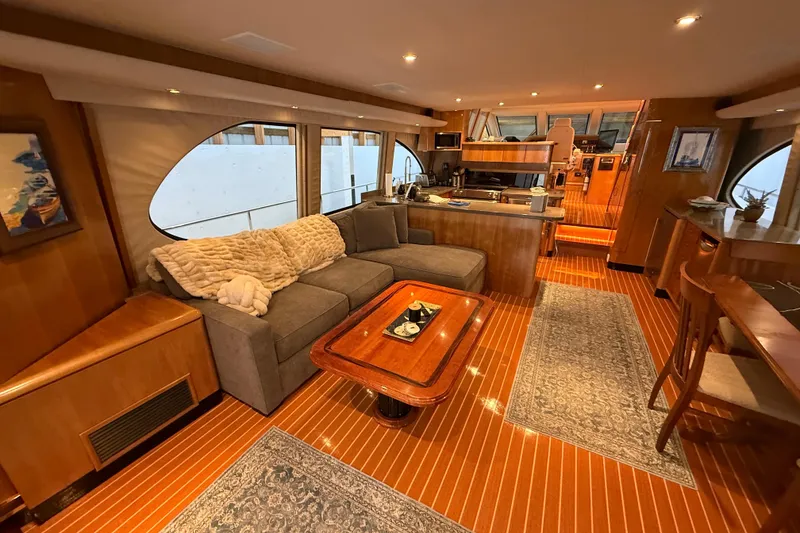 Slide: The Image of Sleek custom motor yacht side view, 2000 model, in a wooden dock setting. - 6