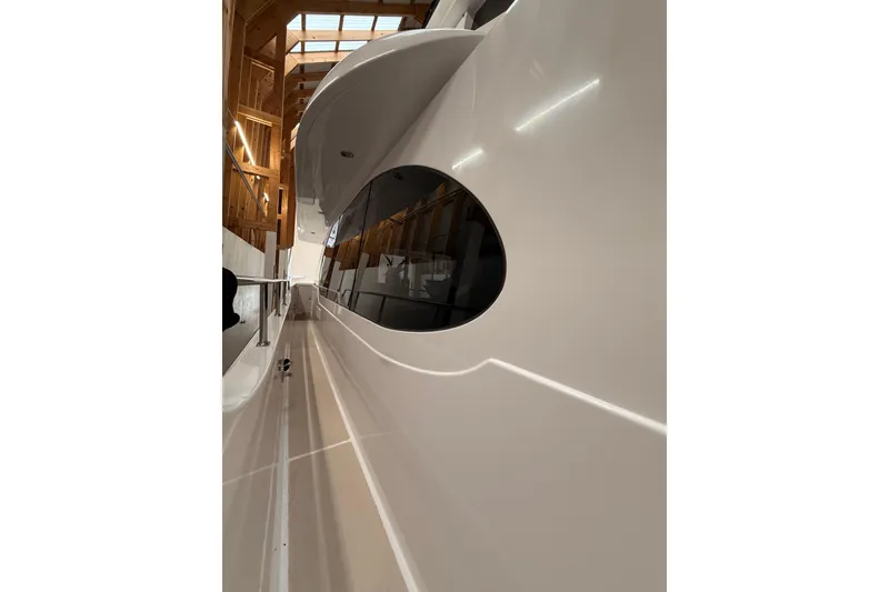 Slide: The Image of White crane arm on 2000 Northern Pacific Motor Yacht in a wooden boathouse. - 67