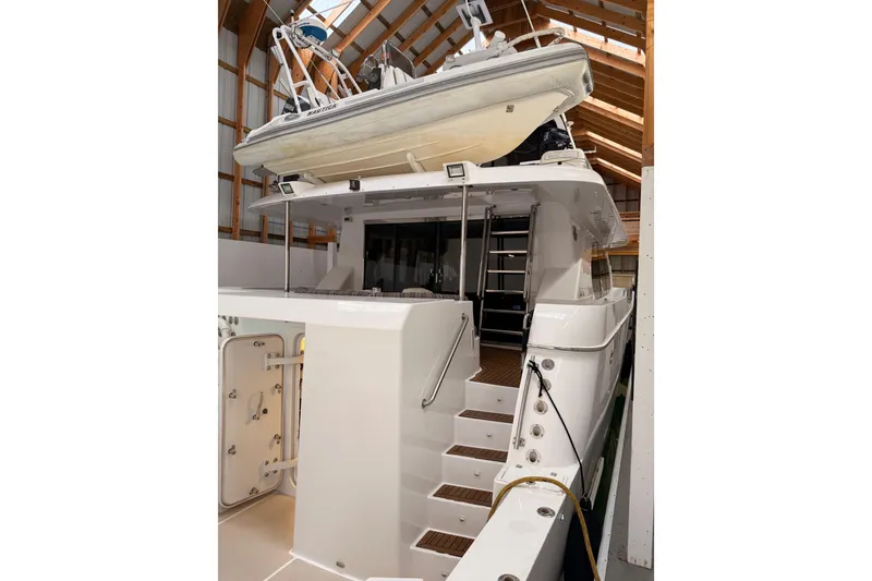 Slide: The Image of Side view of a 2000 Northern Pacific Motor Yacht in a wooden boathouse. - 72