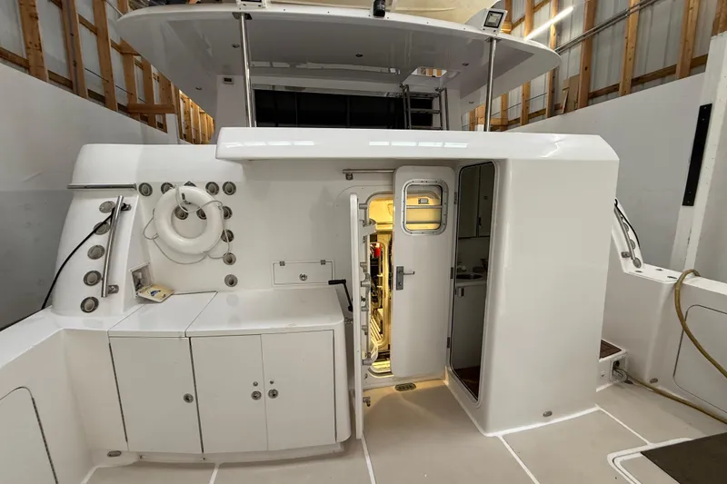 Slide: The Image of Northern Pacific 2000 Motor Yacht in wooden boathouse, showcasing sleek deck design. - 74