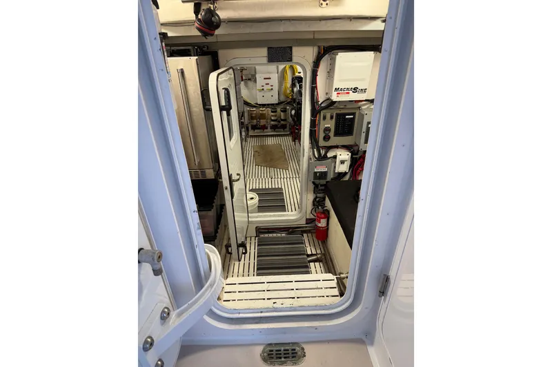 Slide: The Image of Northern Pacific 2000 Motor Yacht in storage, featuring a dinghy on the upper deck. - 76