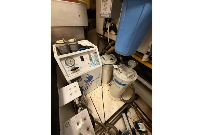 Slide: The Image of Compact bathroom in 2000 Northern Pacific Motor Yacht with sink, toilet, and wooden floor mat. - 79