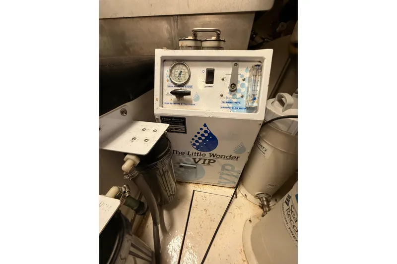 Slide: The Image of Engine room of 2000 Northern Pacific Motor Yacht, featuring equipment and safety gear. - 80