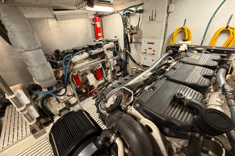 Slide: The Image of Engine room of 2000 Northern Pacific Motor Yacht with mechanical components and wiring. - 85