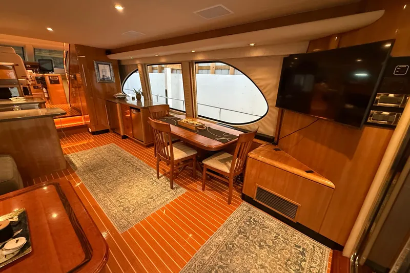 Slide: The Image of Luxurious interior of a 2000 Northern Pacific Motor Yacht with elegant furnishings and wood flooring. - 9