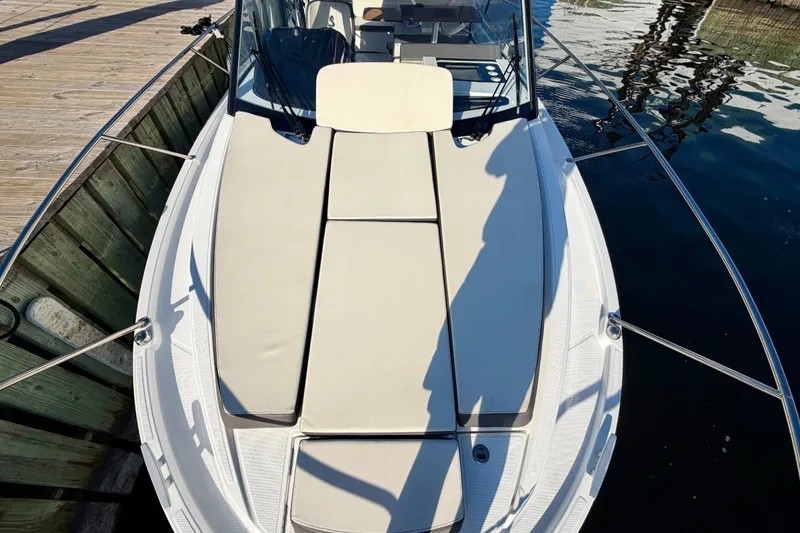 Slide: The Image of 2021 Beneteau Antares 9 boat with sunbathing deck, docked by wooden pier. - 11