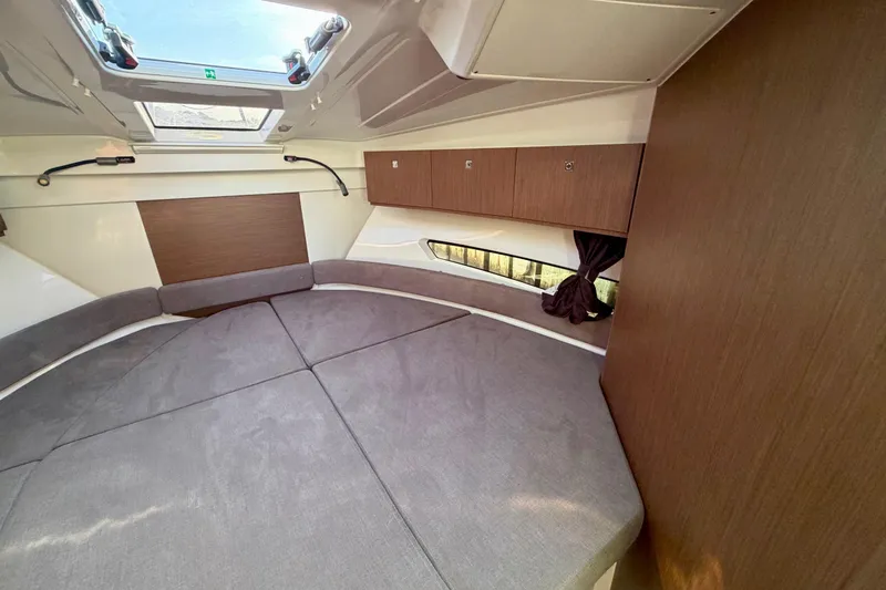 Slide: The Image of Interior cabin of 2021 Beneteau Antares 9 with cozy seating and wood accents. - 20