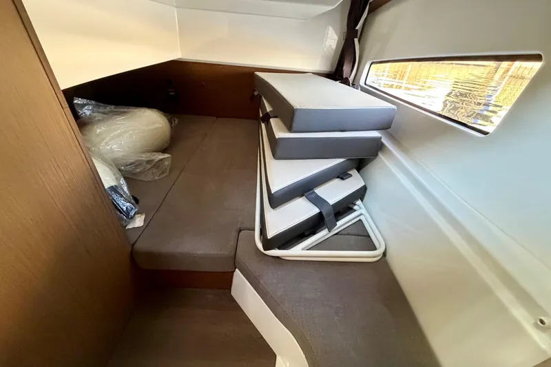 Slide: The Image of Interior cabin of 2021 Beneteau Antares 9 with cushions and window view. - 22