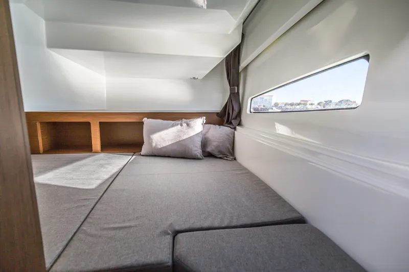 Slide: The Image of 2021 Beneteau Antares 9 boat on a calm lake under clear blue sky. - 6