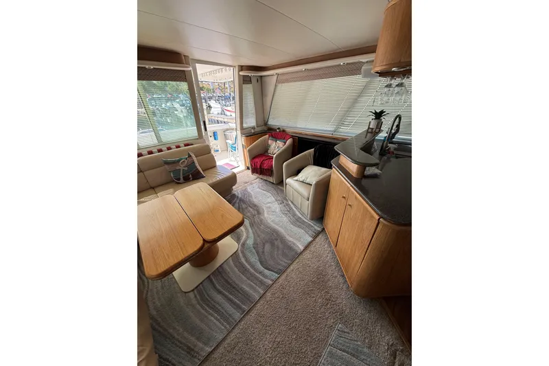 Slide: The Image of Luxurious interior of a 1997 Bayliner 47 Motoryacht with elegant seating and wooden furnishings. - 14