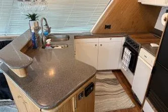 Slide: The Image of 1997 Bayliner 47 Motoryacht kitchen with modern appliances and sleek countertops. - 15