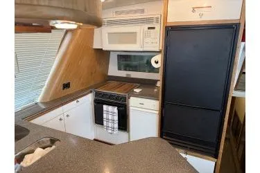 Slide: The Image of 1997 Bayliner 47 Motoryacht kitchen with modern appliances and sleek countertops. - 16
