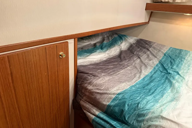 Slide: The Image of Cozy cabin interior of 1997 Bayliner 47 Motoryacht with colorful bedding. - 21