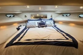Slide: The Image of Luxurious bedroom interior of 1997 Bayliner 47 Motoryacht with elegant bedding. - 23