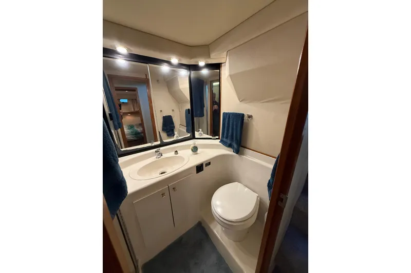 Slide: The Image of Bathroom interior of 1997 Bayliner 47 Motoryacht with sink, mirror, and toilet. - 26