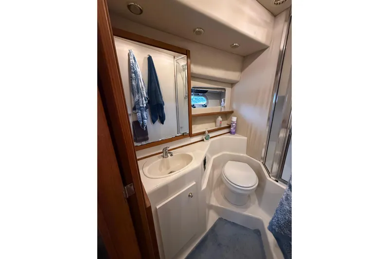 Slide: The Image of Bathroom interior of 1997 Bayliner 47 Motoryacht with sink, toilet, and mirror. - 27