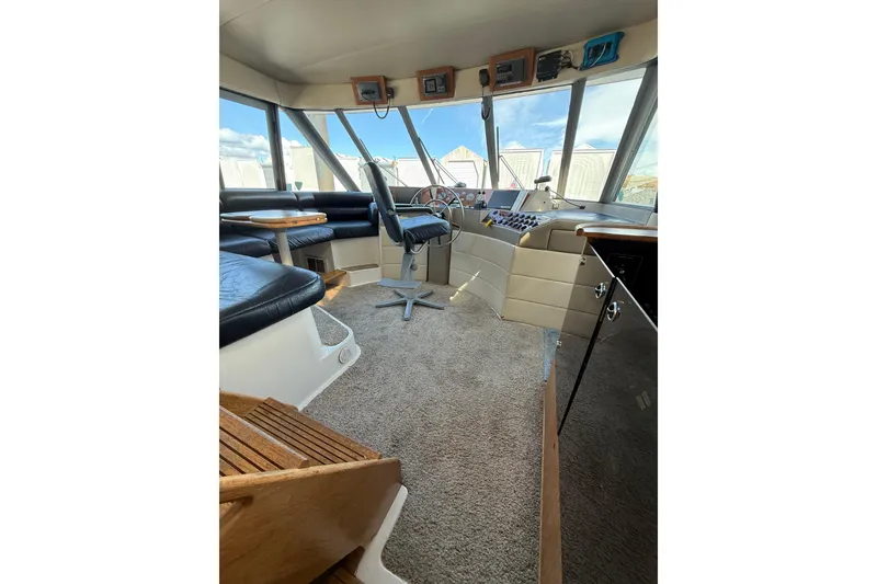 Slide: The Image of Interior of 1997 Bayliner 47 Motoryacht with helm, seating, and panoramic windows. - 7