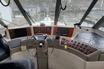 Slide: The Image of 1997 Bayliner 47 Motoryacht helm with steering wheel and control panel. - 9