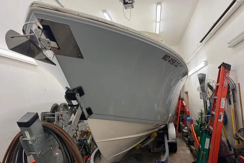 The Image of 2016 Cobia 296 Center Console boat in storage, side view with equipment. - 0