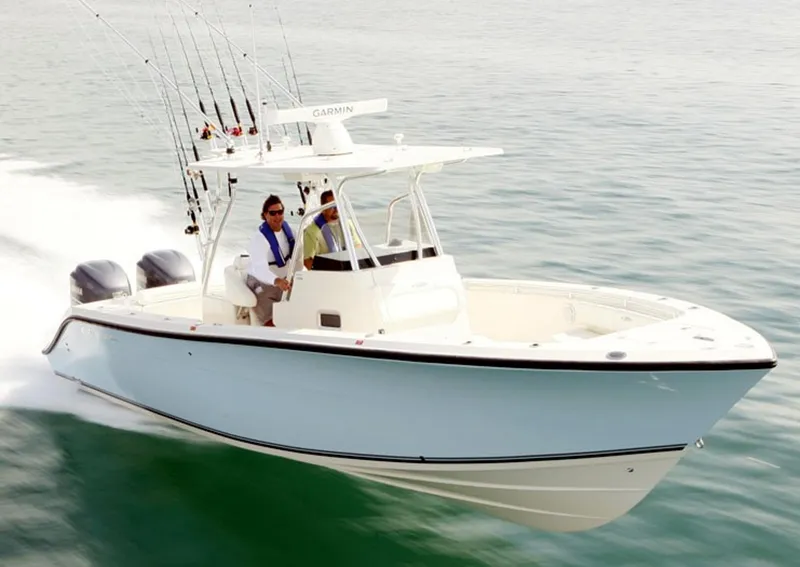 Slide: The Image of 2016 Cobia 296 Center Console boat with sleek design and logo detail. - 1