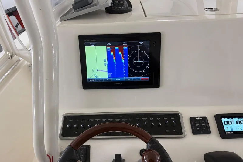 Slide: The Image of 2016 Cobia 296 Center Console dashboard with Garmin navigation display. - 12