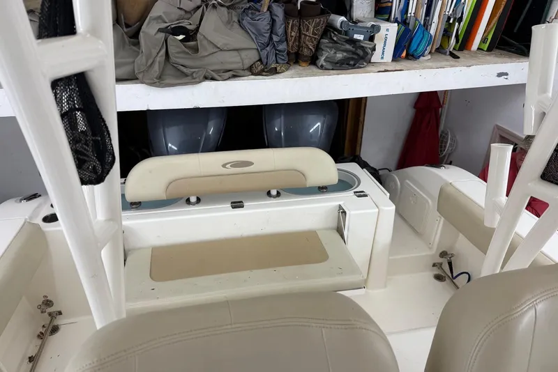 Slide: The Image of 2016 Cobia 296 Center Console boat interior with storage and seating area. - 19
