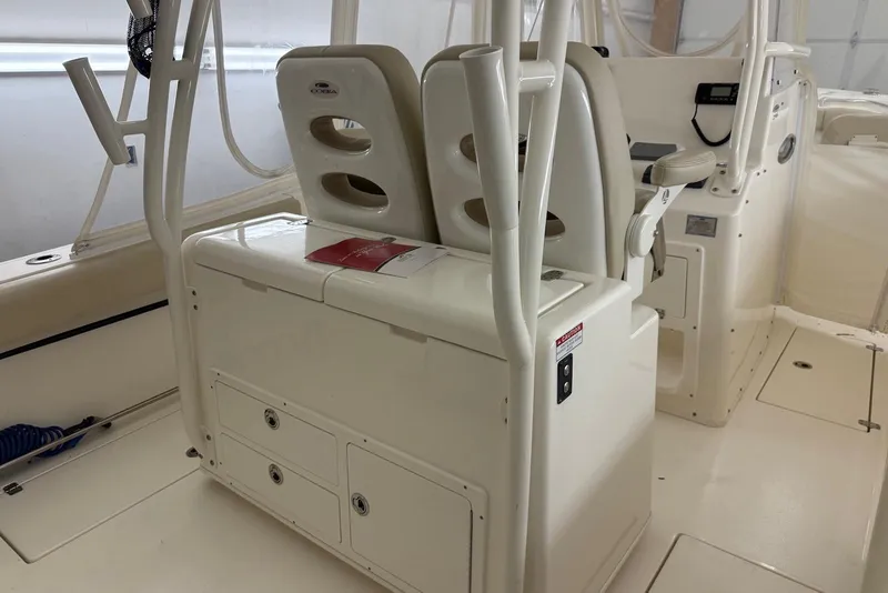 Slide: The Image of 2016 Cobia 296 Center Console boat interior with seating and storage compartments. - 21