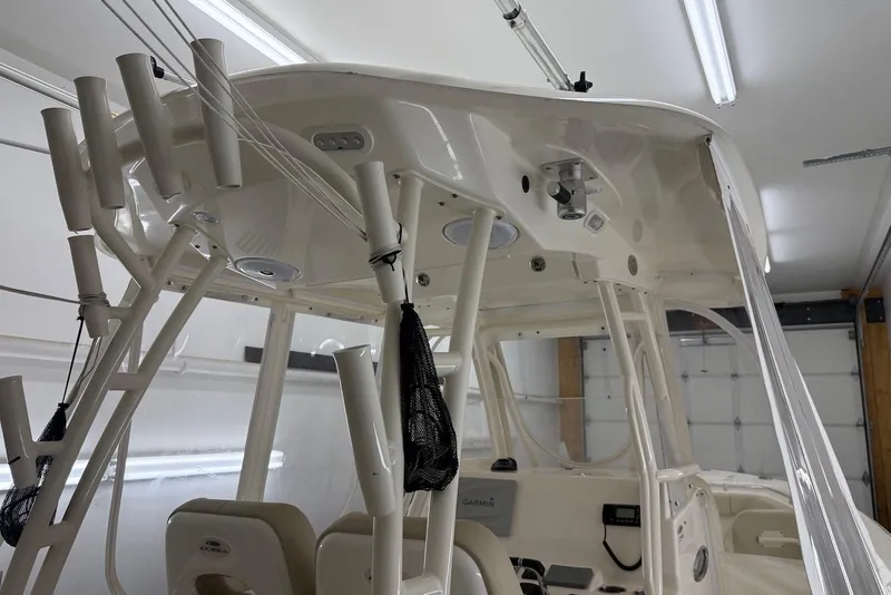 Slide: The Image of 2016 Cobia 296 Center Console boat interior with rod holders and electronics. - 22