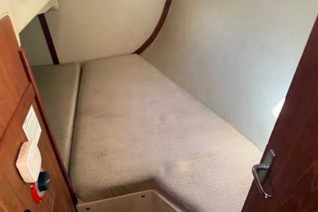 Slide: The Image of Interior of 1989 Hunter 35.5 sailboat with wooden cabinetry and cozy seating area. - 3