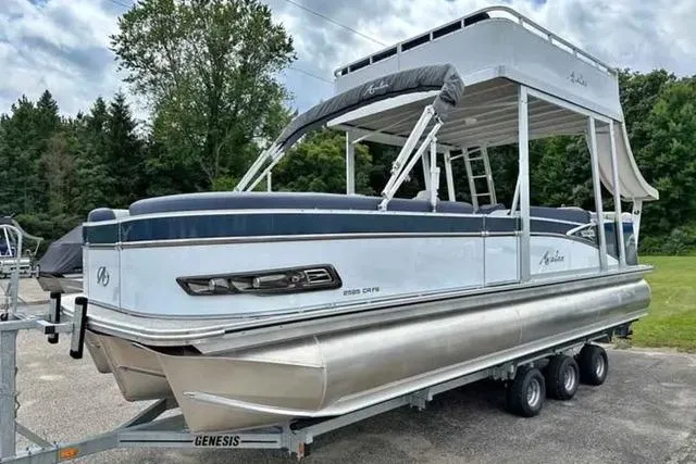 The Image of 2023 Avalon Catalina Funship 2585 pontoon boat on trailer, parked outdoors. - 0