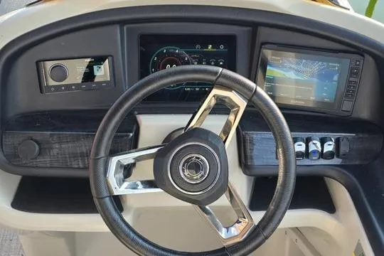 Slide: The Image of 2023 Avalon Catalina Funship 2585 dashboard with steering wheel and digital displays. - 4