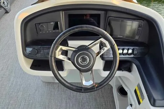 Slide: The Image of 2023 Avalon Catalina Funship 2585 dashboard with steering wheel and control panel. - 9