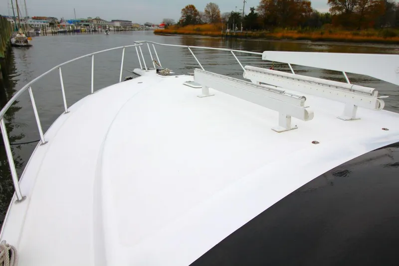 Slide: The Image of 1999 Ocean Yachts 60 Super Sport yacht deck, docked in a calm marina. - 20