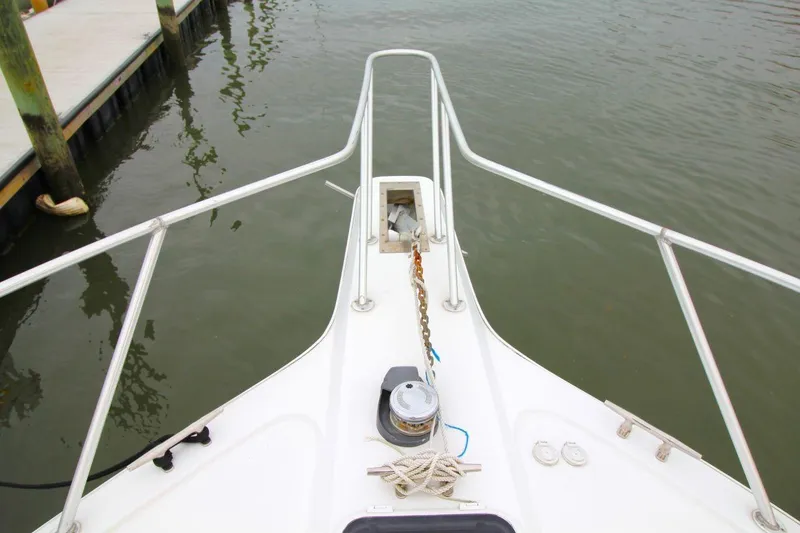 Slide: The Image of Bow view of 1999 Ocean Yachts 60 Super Sport, featuring anchor and railing. - 21
